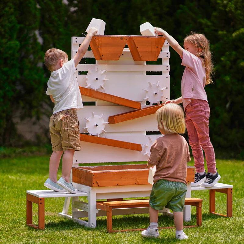Children playing with a wooden play structure in a garden